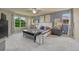 The main bedroom features lots of natural lighting, a tv, a stool and area for relaxing at 15235 W Iliff Ave, Lakewood, CO 80228