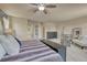Spacious bedroom features neutral colors, ceiling fan, and plentiful natural light at 15235 W Iliff Ave, Lakewood, CO 80228