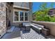 Cozy outdoor patio with comfortable seating, a fire pit, and a stylish black and white patterned rug at 15235 W Iliff Ave, Lakewood, CO 80228