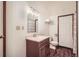 Bathroom featuring wood vanity, mirror and wood-look flooring at 1661 S Fulton St, Aurora, CO 80247