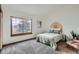 Bright bedroom with a large window, neutral carpet, and modern decor at 1661 S Fulton St, Aurora, CO 80247