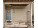 Charming townhouse entrance with a welcoming blue door, decorative wreath, and wooden steps at 1661 S Fulton St, Aurora, CO 80247