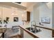 Kitchen with stainless steel appliances, white cabinets, and wood-trimmed countertops at 1661 S Fulton St, Aurora, CO 80247