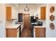 Efficient kitchen with wooden cabinets, white countertops, and modern appliances at 1661 S Fulton St, Aurora, CO 80247