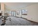 Spacious living room with ample natural light, sliding glass door, and carpeted floors at 1661 S Fulton St, Aurora, CO 80247