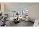 Bright and spacious living room with a cozy fireplace and abundant natural light from large windows and a sliding glass door at 1661 S Fulton St, Aurora, CO 80247
