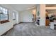 Clean, neutral living room featuring natural light, a cozy fireplace, and an open layout at 1661 S Fulton St, Aurora, CO 80247