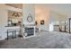 Inviting living space with a cozy fireplace, open kitchen view, and adjacent dining area at 1661 S Fulton St, Aurora, CO 80247