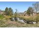 Exterior view of pond with neighborhood in background at 1661 S Fulton St, Aurora, CO 80247