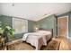 Serene bedroom with hardwood floors, large window, and a cozy, neutral-toned aesthetic at 895 Vance St, Lakewood, CO 80214