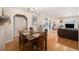 Open dining room with hardwood floors, natural light, and a view into the living room at 895 Vance St, Lakewood, CO 80214