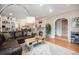 Inviting living room featuring a stone fireplace, hardwood floors, and a comfortable leather sofa at 895 Vance St, Lakewood, CO 80214