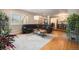 Bright living area with hardwood floors, large window, and a stylish, comfortable seating arrangement at 895 Vance St, Lakewood, CO 80214