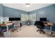 Office space with neutral walls, carpet, built-in shelves, and windows for lots of natural light at 895 Vance St, Lakewood, CO 80214