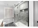 Contemporary shower with grey marble-like tiles and a seamless glass door at 895 Vance St, Lakewood, CO 80214