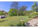 Backyard with grassy area, picnic table, dog house and various trees at 430 S Potomac Cir, Aurora, CO 80012