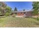 Large backyard with a brick house, solar panels and picnic table at 430 S Potomac Cir, Aurora, CO 80012