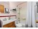 Bathroom features a shower-tub combo with modern fixtures and a ceramic tile backsplash at 430 S Potomac Cir, Aurora, CO 80012