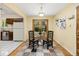 Bright dining area featuring hardwood floors with a glass table and views of the kitchen at 430 S Potomac Cir, Aurora, CO 80012
