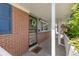 Covered front porch and brick exterior features decorative door, hello mat, and small adjacent window at 430 S Potomac Cir, Aurora, CO 80012