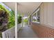 Covered front porch with view of brick exterior, siding, and white railing and supports at 430 S Potomac Cir, Aurora, CO 80012