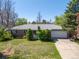 Beautiful single-story home with manicured front yard and attached two-car garage with long driveway at 430 S Potomac Cir, Aurora, CO 80012
