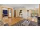 Open-concept living room featuring hardwood floors with access to dining area, kitchen, and study at 430 S Potomac Cir, Aurora, CO 80012