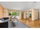 Well-lit living room featuring hardwood floors, a gray sofa, and contemporary decor at 430 S Potomac Cir, Aurora, CO 80012
