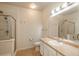 Bathroom featuring a shower with glass doors, a large mirror, and great lighting at 13456 Via Varra # 208, Broomfield, CO 80020