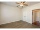 Bedroom featuring a ceiling fan, double closets, and an attached bathroom at 13456 Via Varra # 208, Broomfield, CO 80020