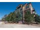 Attractive multi-story building with mature landscaping and clear blue sky at 13456 Via Varra # 208, Broomfield, CO 80020