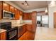 Contemporary kitchen with stainless appliances, wood cabinets, and a convenient breakfast bar at 13456 Via Varra # 208, Broomfield, CO 80020