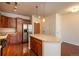 Modern kitchen boasts stainless steel appliances, wood cabinets, and an island with pendant lighting at 13456 Via Varra # 208, Broomfield, CO 80020