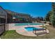 Relaxing pool area featuring a hot tub, covered pool, outdoor fireplace, and comfortable seating for residents' enjoyment at 13456 Via Varra # 208, Broomfield, CO 80020