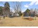 Expansive backyard with a trampoline, patio, and mature trees at 3326 S Geneva St, Denver, CO 80231