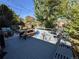 Outdoor deck area with a picnic table and bench seating under decorative string lights at 3326 S Geneva St, Denver, CO 80231