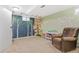 A basement playroom with climbing wall, tree painting, cushioned seat, and comfortable chair at 3326 S Geneva St, Denver, CO 80231