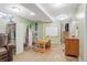 Basement area with playful decor, including a small desk, whiteboard, and a work table at 3326 S Geneva St, Denver, CO 80231