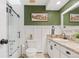 Bathroom with sliding glass shower doors, white wainscotting, and a granite vanity with framed artwork at 3326 S Geneva St, Denver, CO 80231