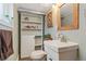 Cozy bathroom with a unique sink, decorative mirror, storage shelves, and stylish design elements at 3326 S Geneva St, Denver, CO 80231