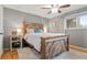 Cozy bedroom with a rustic wooden bed frame, soft rug, and ample natural light from the window at 3326 S Geneva St, Denver, CO 80231