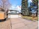 Exterior of home featuring a wide driveway and an attached garage, enhancing curb appeal at 3326 S Geneva St, Denver, CO 80231