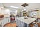 Bright kitchen featuring white cabinetry, stainless steel appliances, and a marble island with pendant lighting at 3326 S Geneva St, Denver, CO 80231