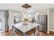 Modern kitchen featuring a center island with seating, stainless steel appliances, and white cabinetry at 3326 S Geneva St, Denver, CO 80231