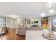 Bright open concept living room features hardwood floors, a staircase, and a view of the kitchen at 3326 S Geneva St, Denver, CO 80231