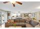 Bright open concept living room features a cozy sectional and a view of the kitchen and dining area at 3326 S Geneva St, Denver, CO 80231