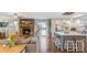 Bright living room with a stone fireplace, hardwood floors, and an open layout with the kitchen island at 3326 S Geneva St, Denver, CO 80231
