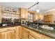 Close up on bar area with wood cabinets, granite countertops and bottle storage at 150 Hess Ave, Golden, CO 80401