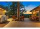 Relaxing deck with rocking chairs showcasing evening mountain views and a built-in tree at 150 Hess Ave, Golden, CO 80401