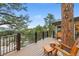 An outdoor space features wood flooring, a tree growing through the deck, and a view of the natural landscape at 150 Hess Ave, Golden, CO 80401